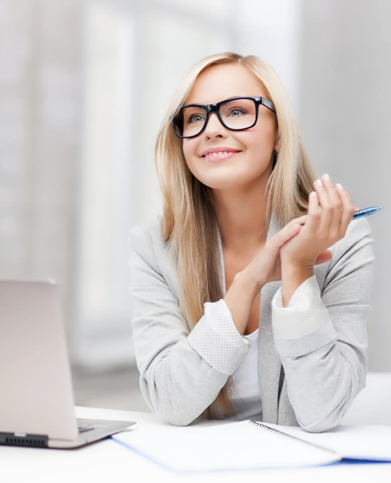 Indoor picture of smiling woman with notebook and pen